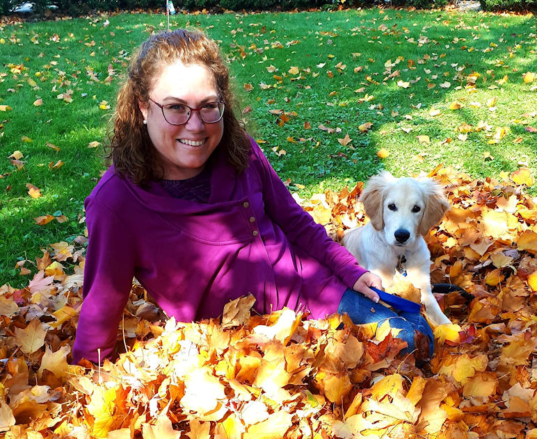 Tracey and her dog in leaves